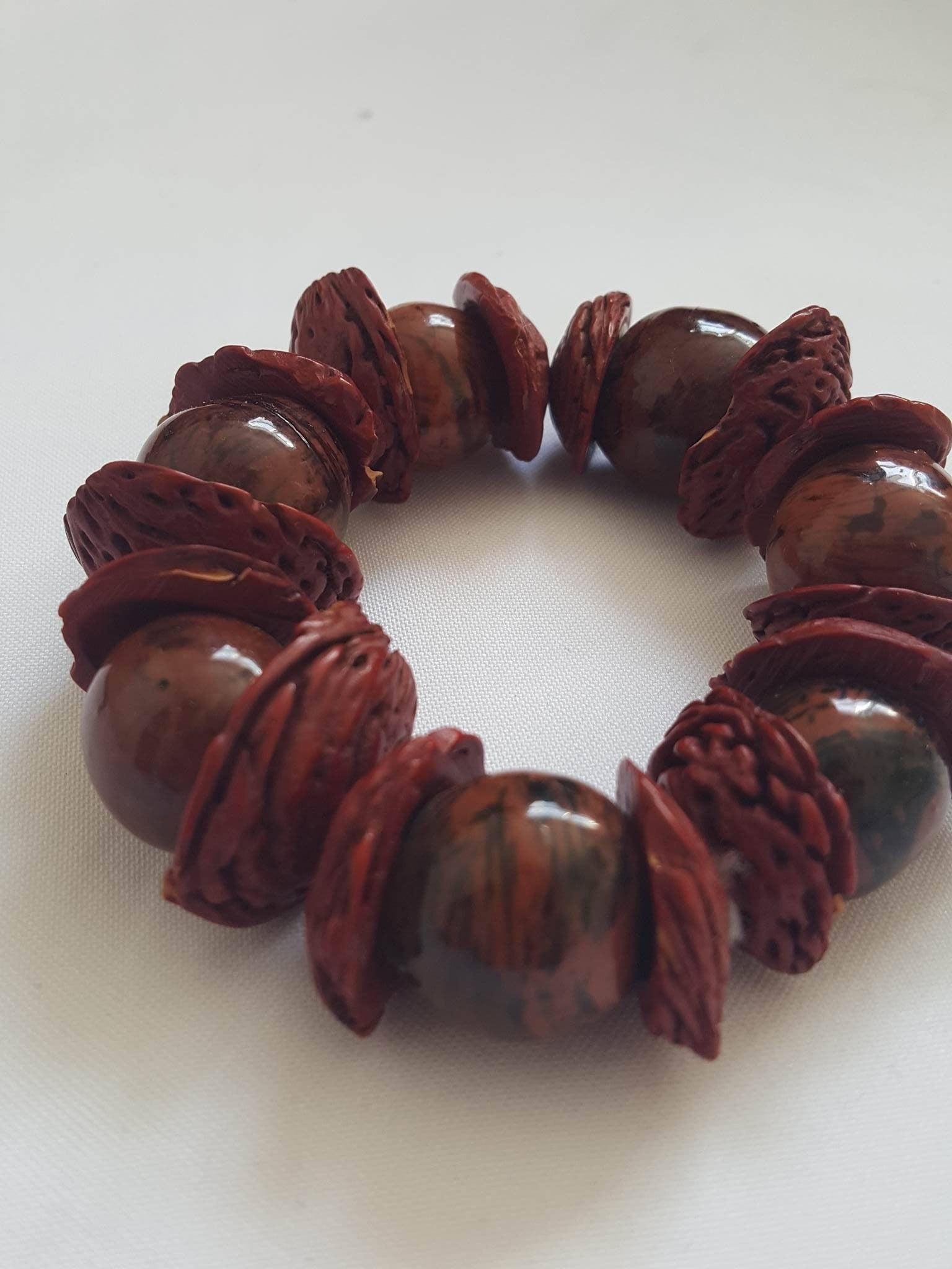 Boho big bracelet handmade using acai beads and peach seeds.