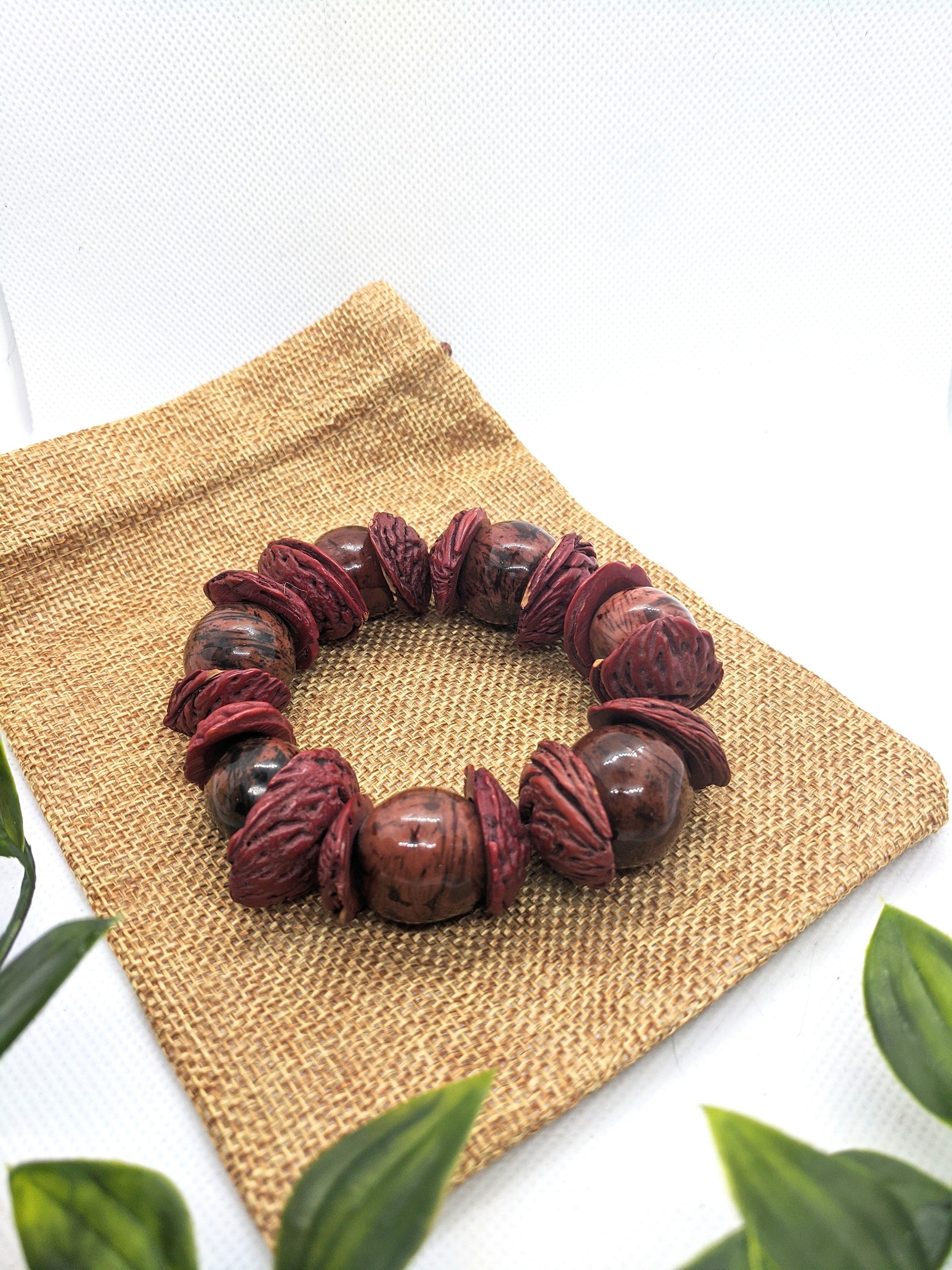 Boho big bracelet handmade using acai beads and peach seeds.