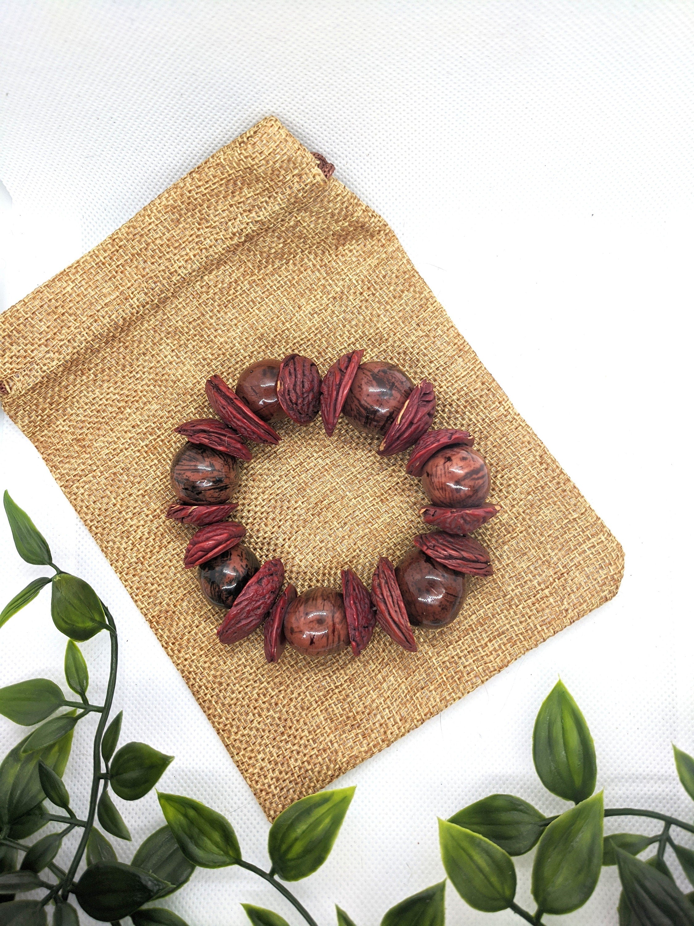 Boho big bracelet handmade using acai beads and peach seeds.