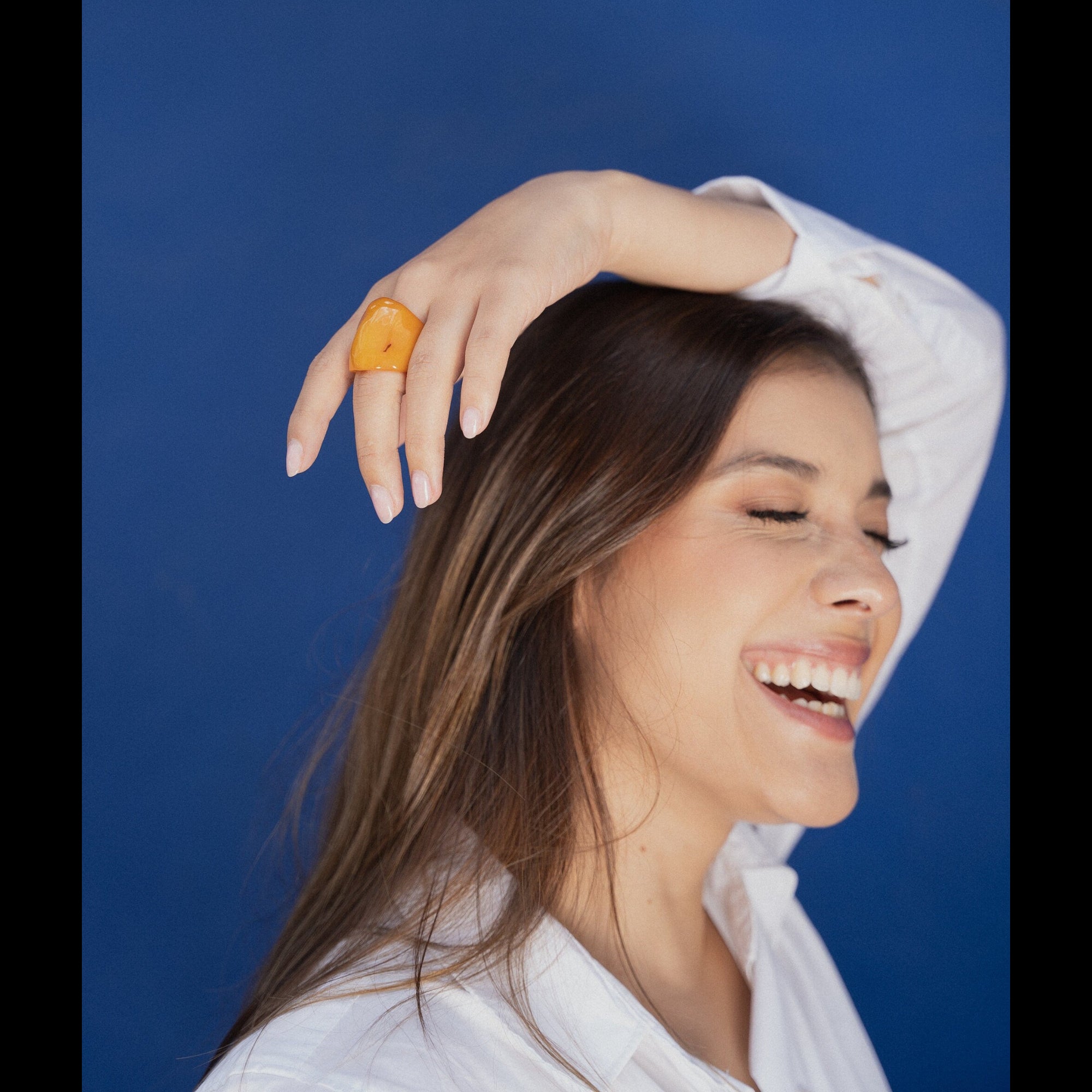 Woman with a yellow ring against a blue background