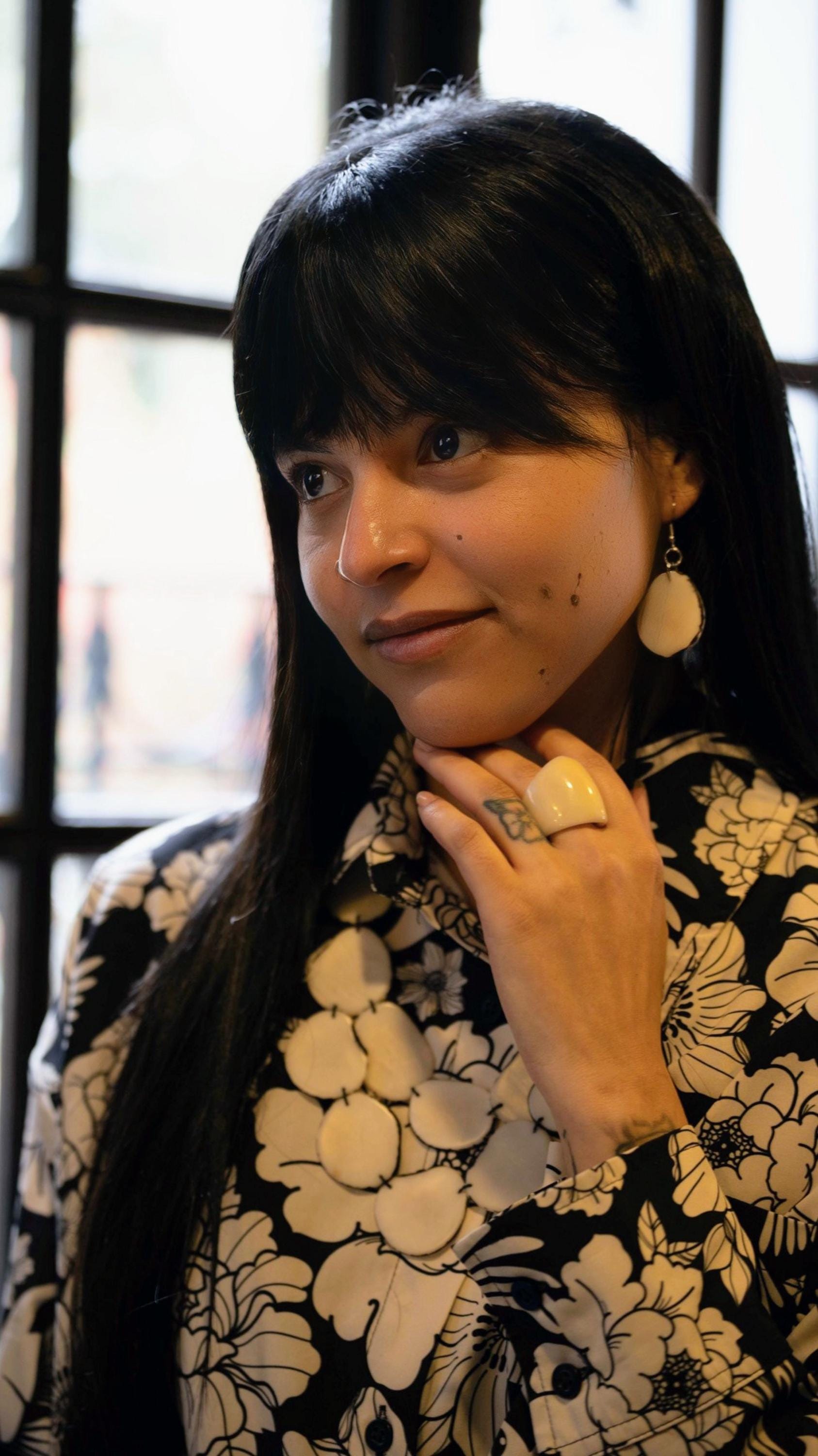 White oval earrings.