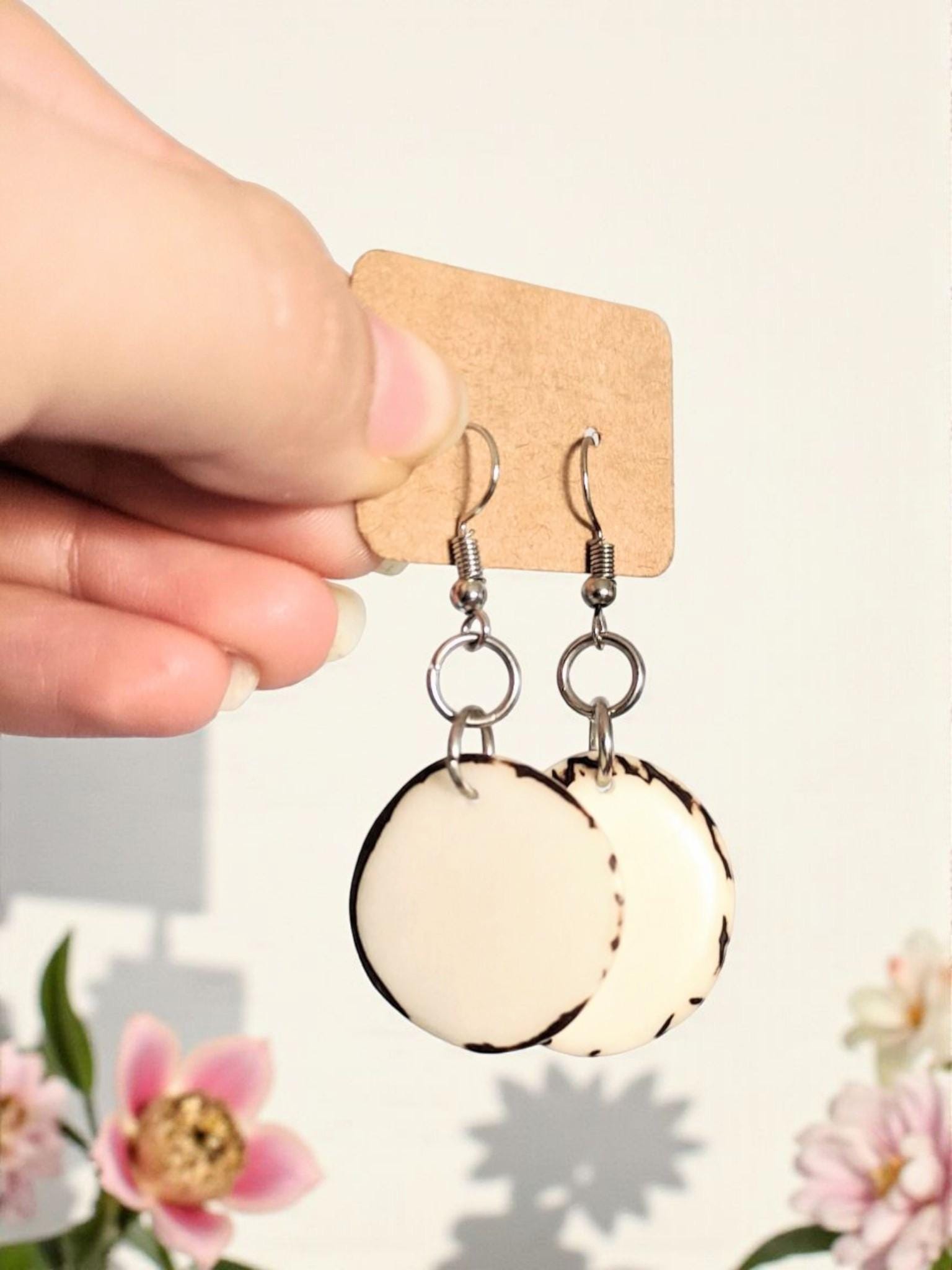 White oval earrings.
