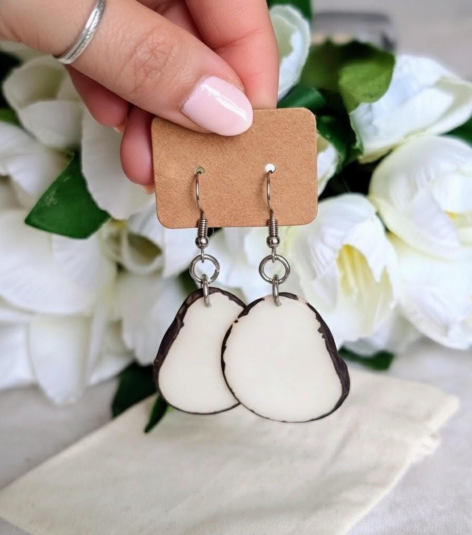 White oval earrings.