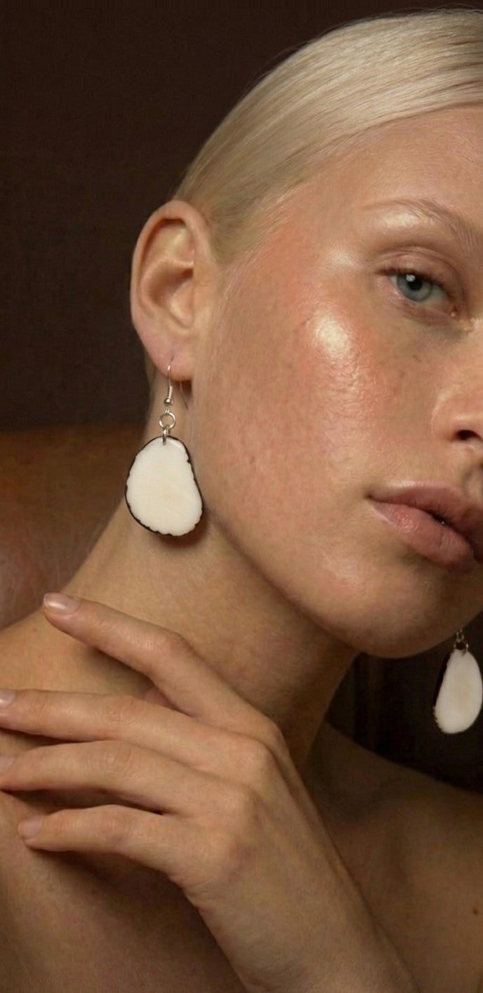White oval earrings.